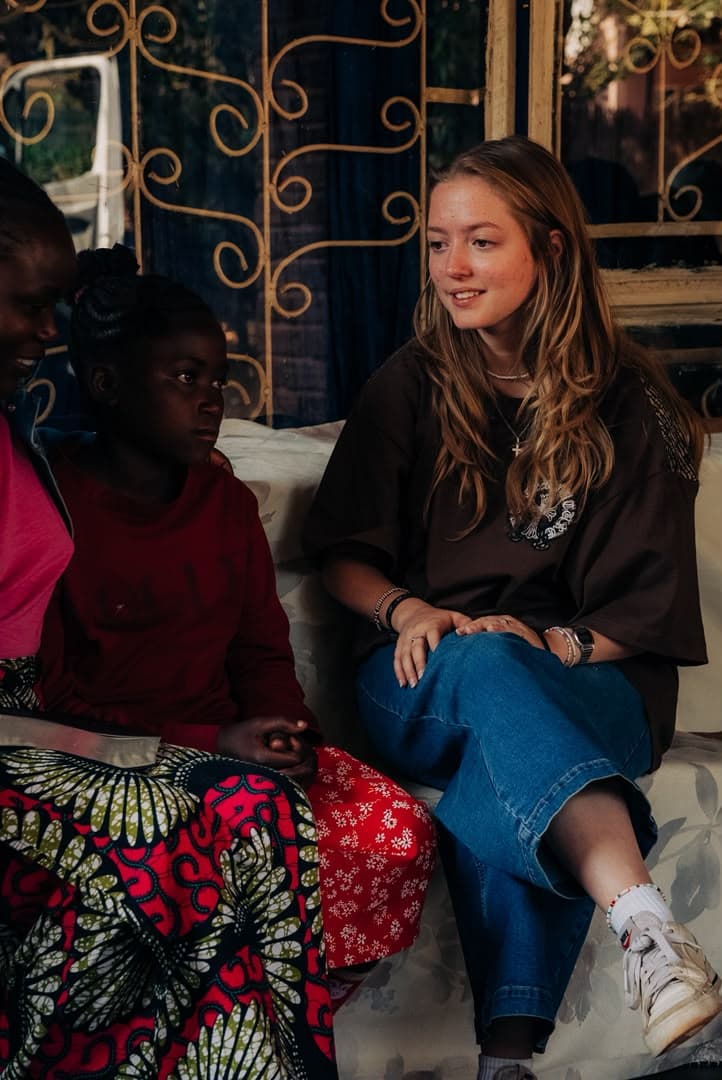 A YWAM Kona team member listening during a community visit